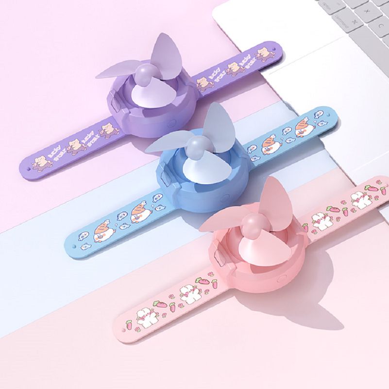 Mini ventilateur ETEK style montre avec batterie 300mAh, 3 couleurs (Violet/Rose/Bleu), comprend câble de chargement + manuel.